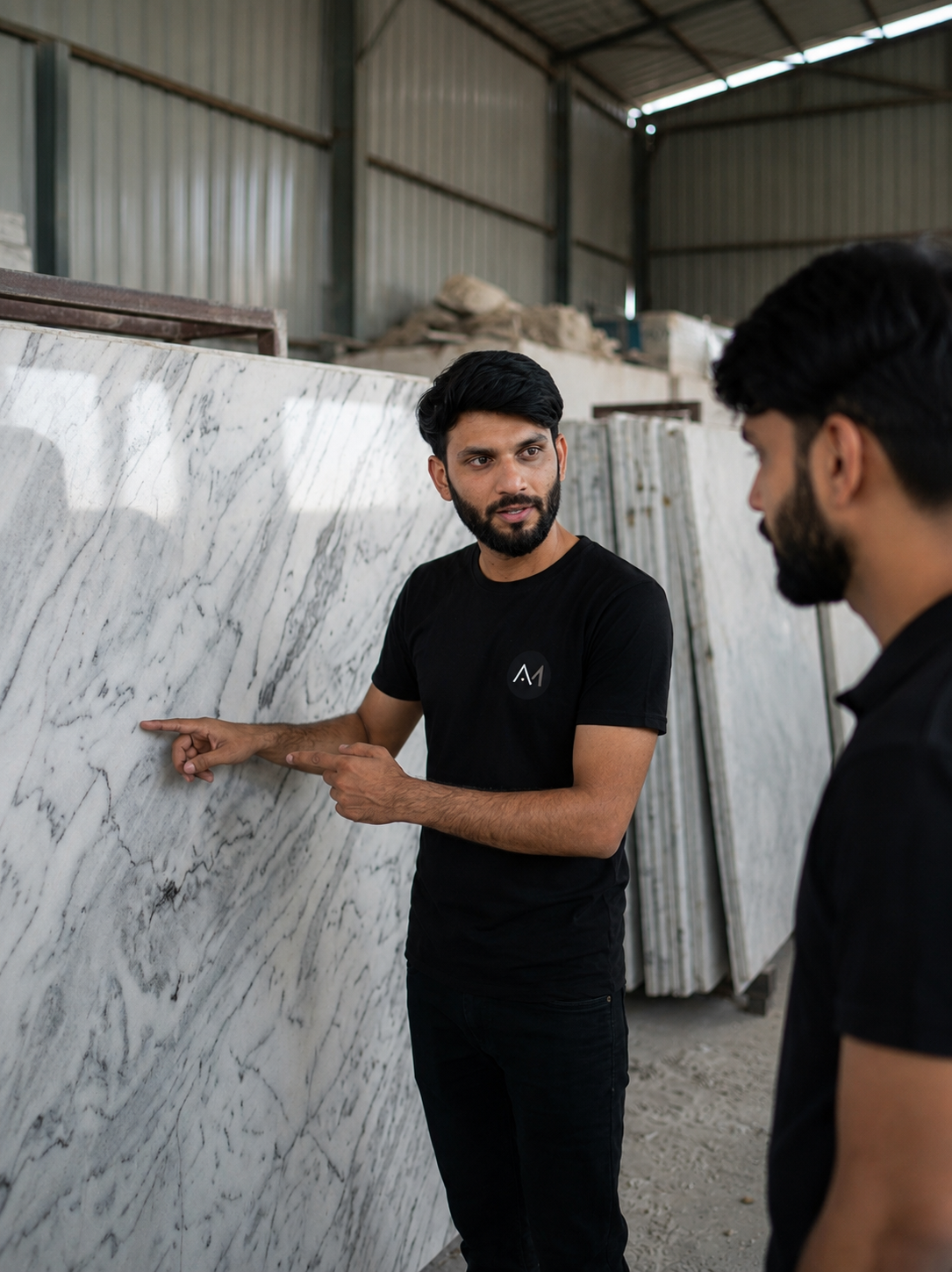 Apna Marble helping a customer inspect and select natural marble